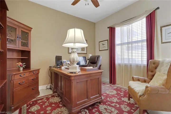 Home office featuring a ceiling fan and baseboards