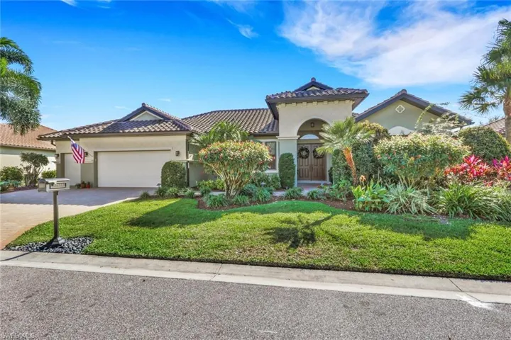 Mediterranean / spanish-style house featuring a front lawn, stucco siding, an attached garage, and decorative driveway