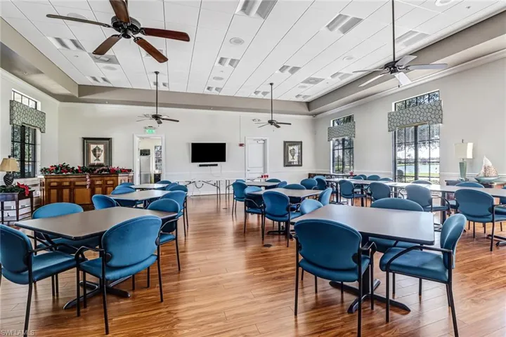 Dining space featuring ceiling fan, a raised ceiling, and light wood-style floors