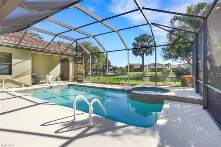 View of swimming pool featuring a sunroom, a patio area, a lanai, and a pool with connected hot tub