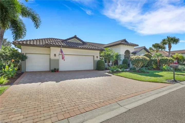 Mediterranean / spanish-style house featuring a front yard, stucco siding, a garage, and decorative driveway