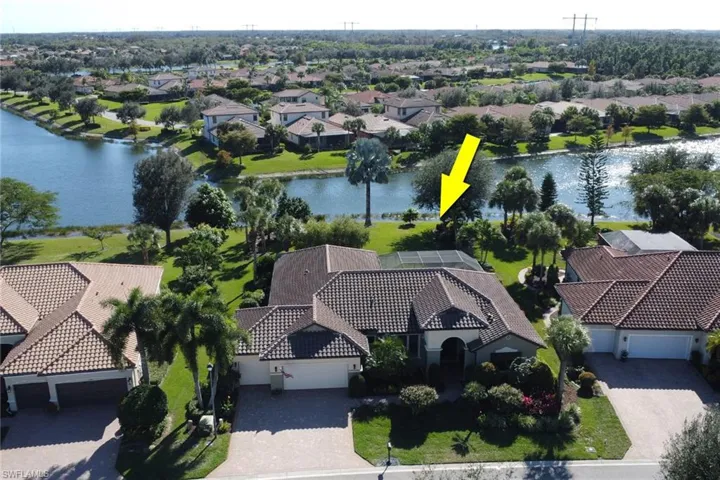 Aerial view of residential area featuring a nearby body of water