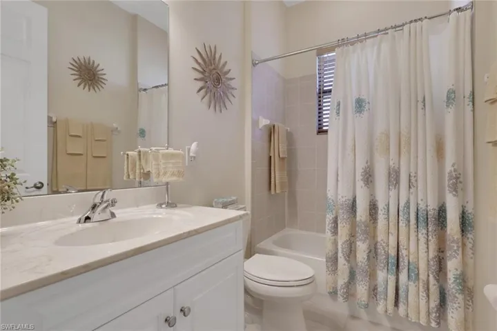 Full bath with vanity and shower / bath combination with curtain
