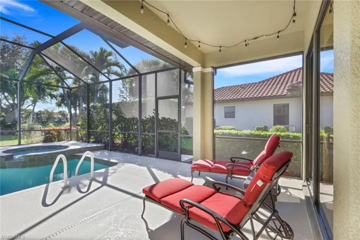 View of pool featuring a patio area, a sunroom, a pool with connected hot tub, and a lanai