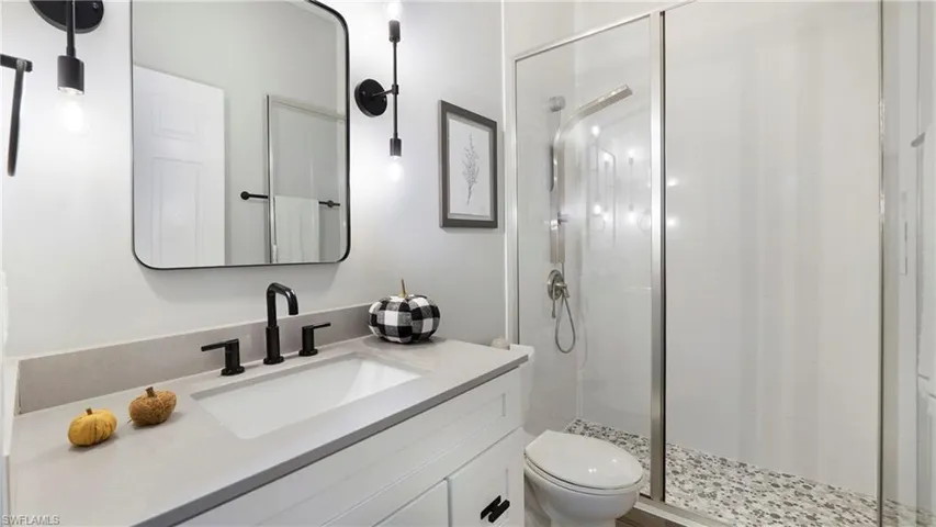 Bathroom with vanity and a stall shower