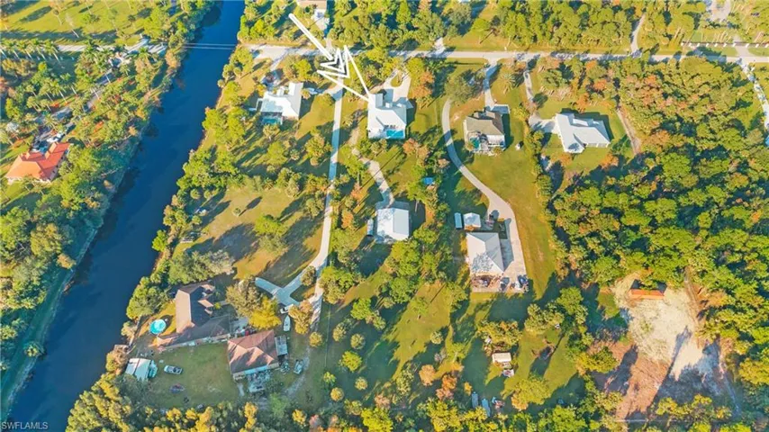 Aerial view of property's location featuring a nearby body of water