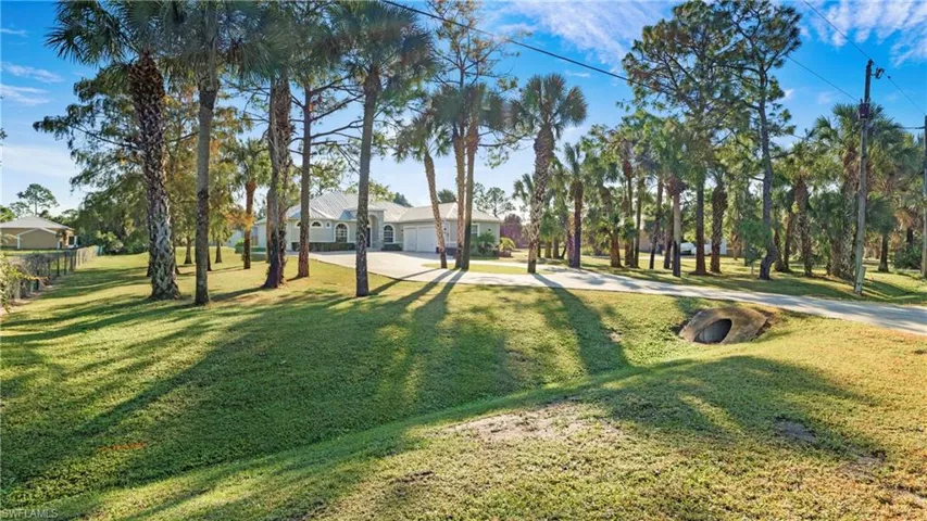 View of green lawn featuring driveway