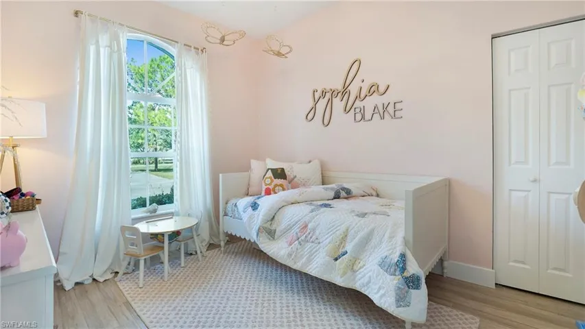 Bedroom featuring light wood-type flooring and a closet