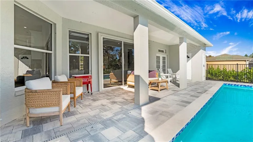View of pool featuring a patio area, an outdoor living space, and french doors