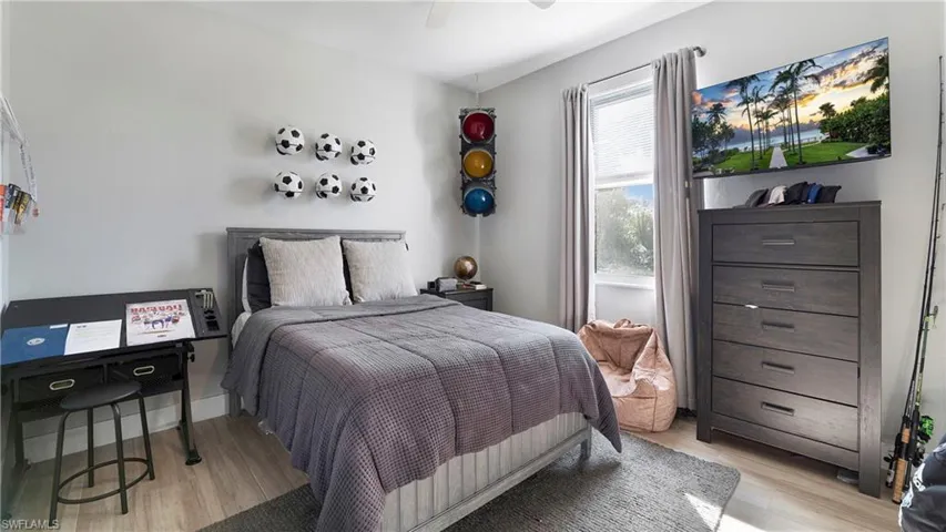 Bedroom with light wood finished floors and a ceiling fan