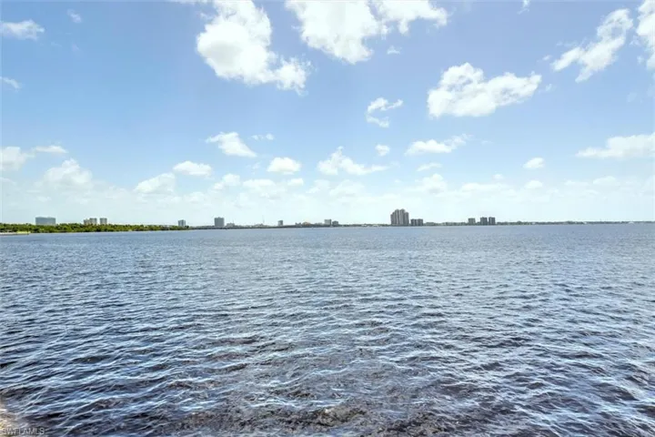 Expansive water frontage with distant city skyline