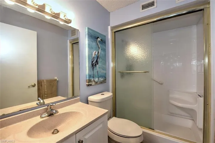 Full bathroom featuring a vanity with an integrated sink, polished chrome faucet, and a large wall-mounted mirror
