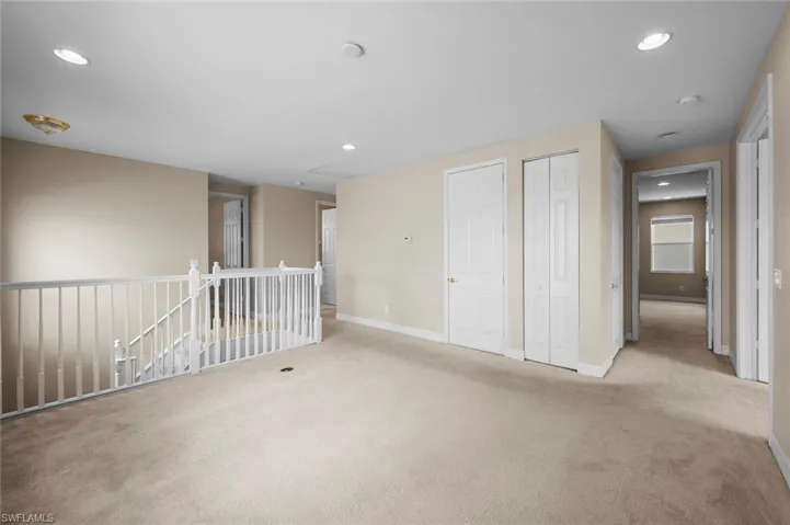 Carpeted empty room featuring recessed lighting and baseboards