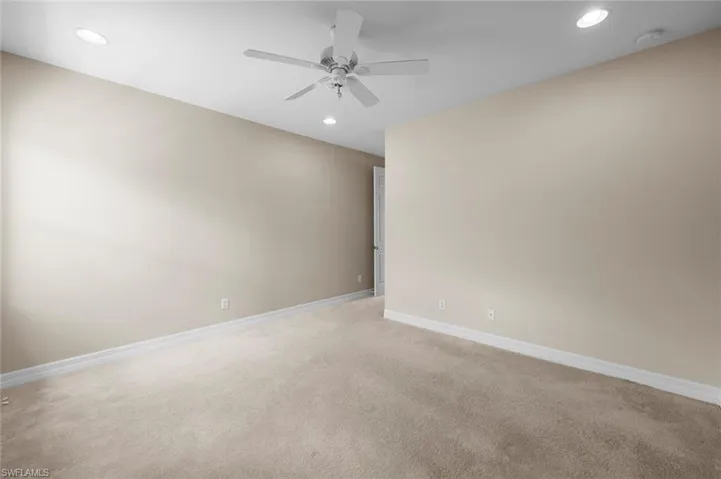 Unfurnished room featuring recessed lighting, light colored carpet, and a ceiling fan
