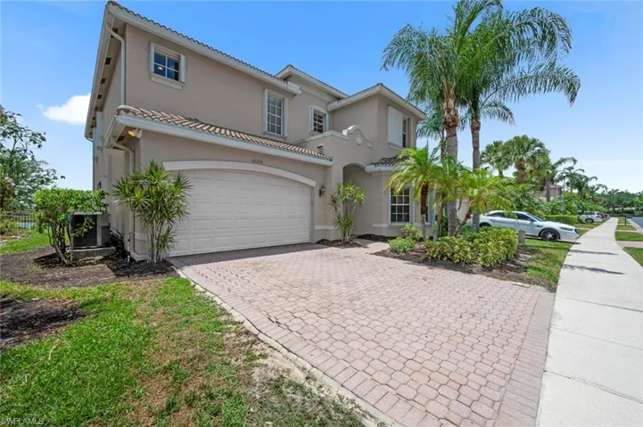 Mediterranean / spanish home featuring decorative driveway, stucco siding, and an attached garage