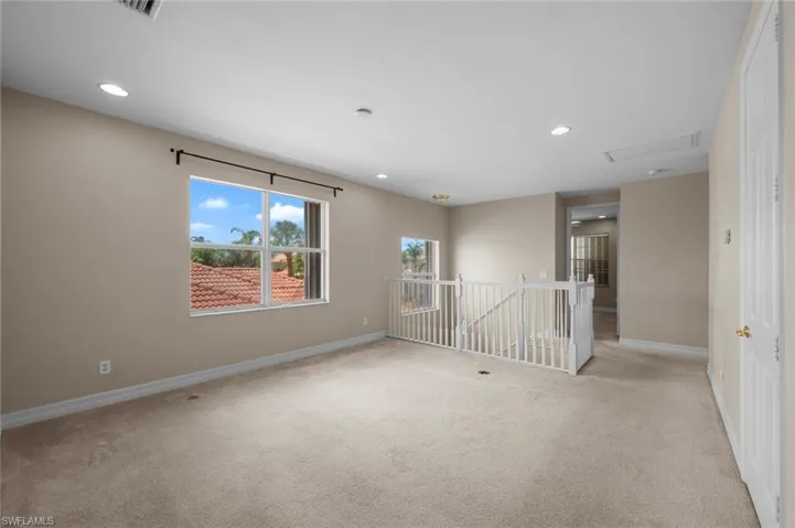 Unfurnished room with light carpet and recessed lighting