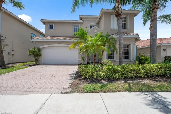 Mediterranean / spanish-style home with decorative driveway, a tiled roof, and stucco siding
