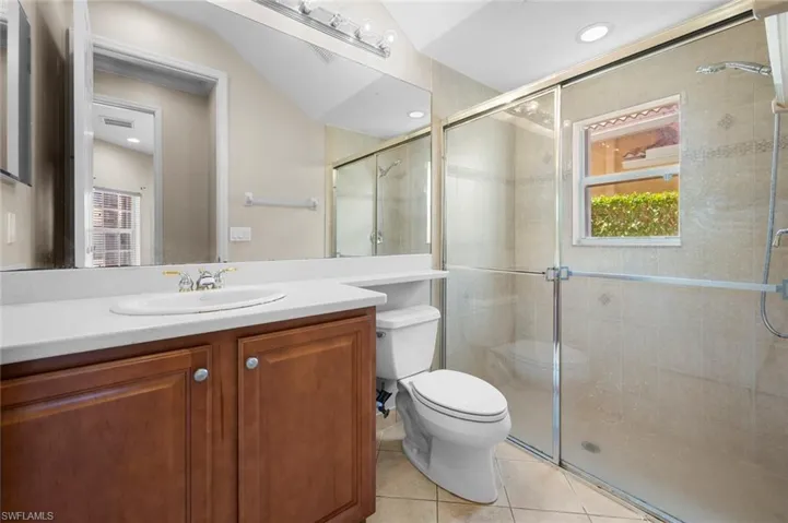 Full bathroom with vanity, light tile patterned floors, a stall shower, and recessed lighting