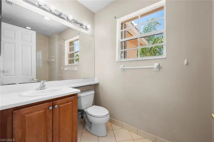 Bathroom featuring light tile patterned floors and vanity