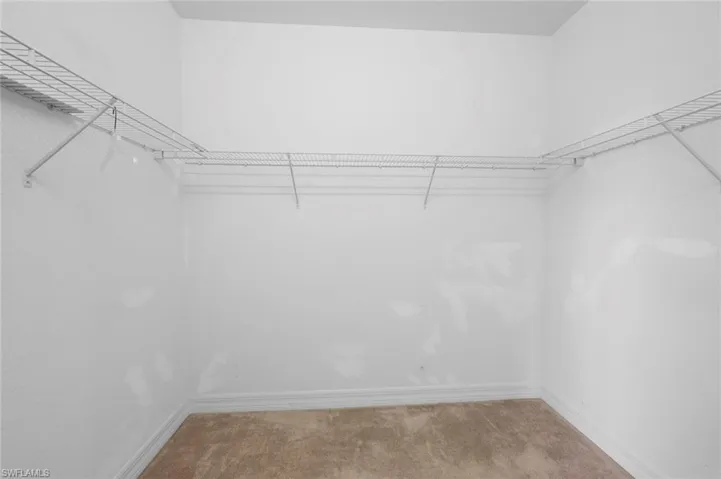 Walk in closet featuring carpet