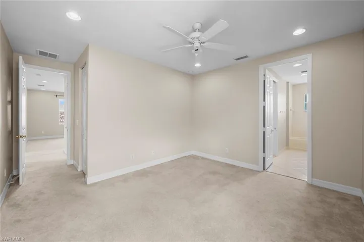 Empty room featuring light colored carpet, recessed lighting, and ceiling fan