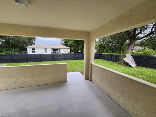 Fenced backyard with a patio area