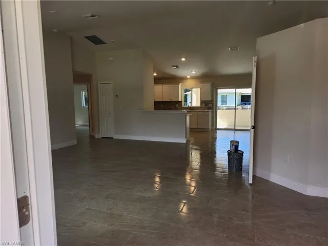 Unfurnished living room featuring baseboards and recessed lighting