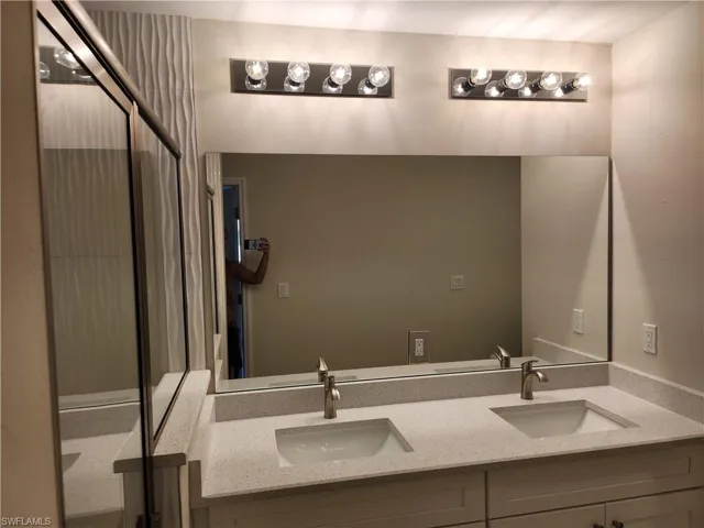 Bathroom with a stall shower and double vanity