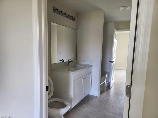 Bathroom with vanity and light tile patterned floors