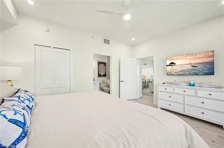 Bedroom with light vinyl tile  flooring, recessed lighting, a closet, and a ceiling fan
