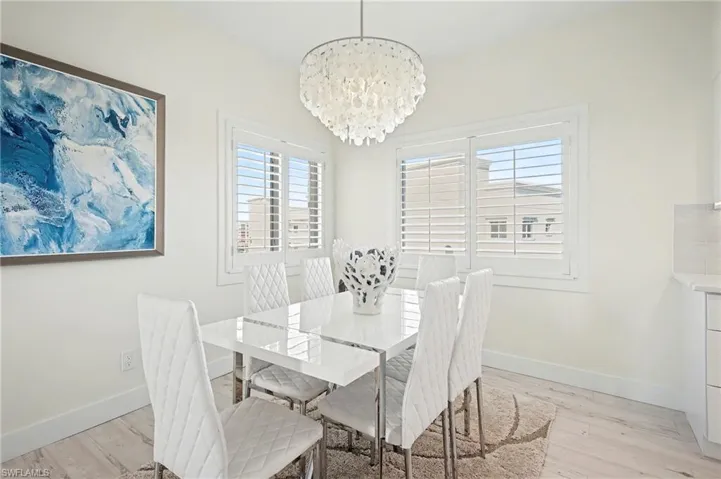 Dining room featuring light flooring and a chandelier