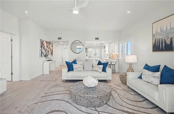 Living room with light tile-type flooring, ceiling fan, and recessed lighting