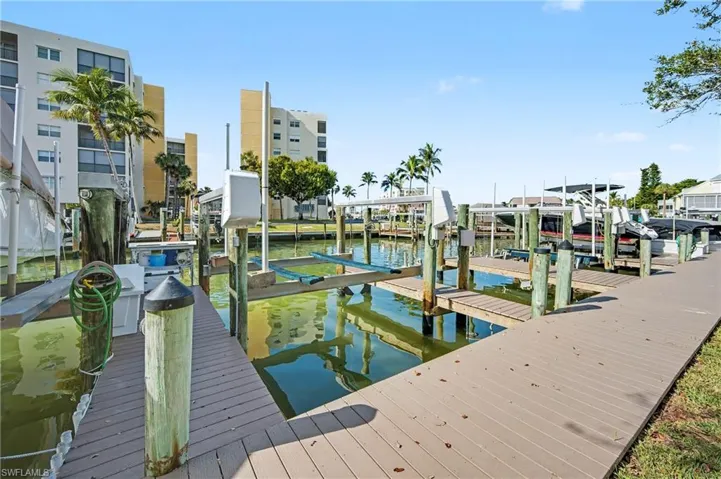 Dock area featuring boat lifts on finger canals.