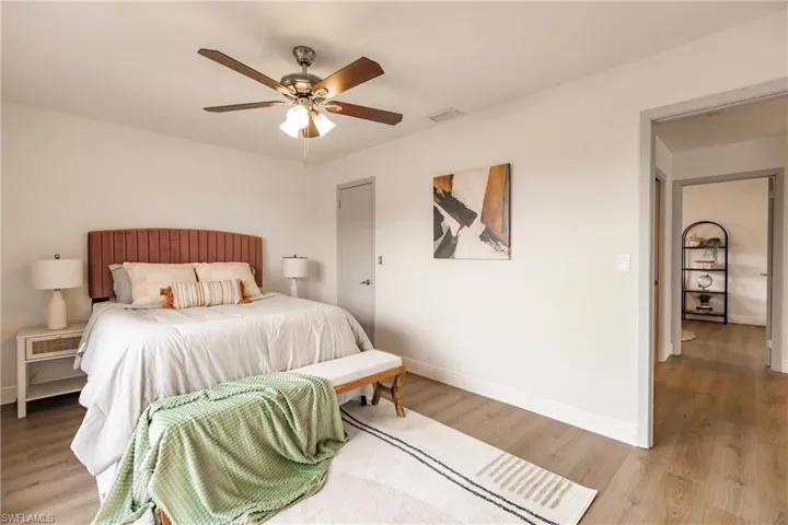 Bedroom featuring wood-type flooring and ceiling fan