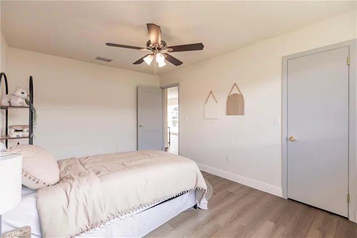 Bedroom with ceiling fan and hardwood / wood-style floors