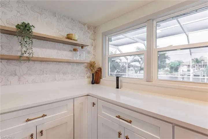 Kitchen featuring white cabinetry