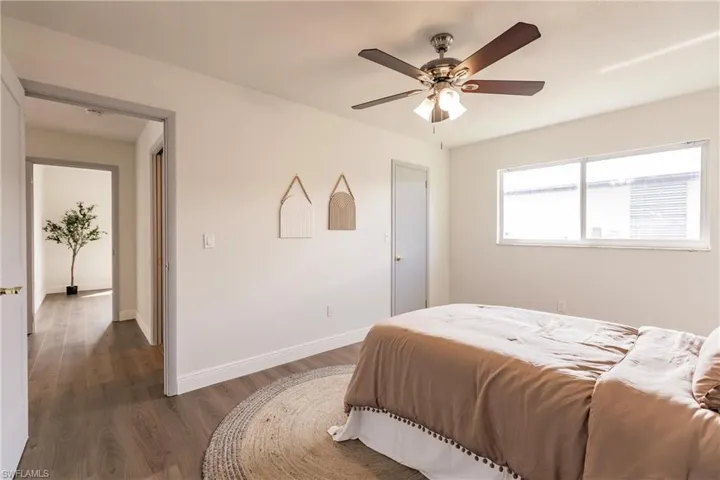 Bedroom featuring ceiling fan and dark hardwood / wood-style flooring