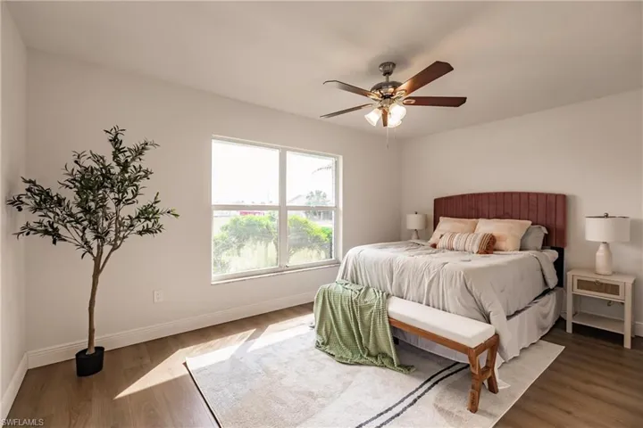 Bedroom with dark hardwood / wood-style flooring and ceiling fan