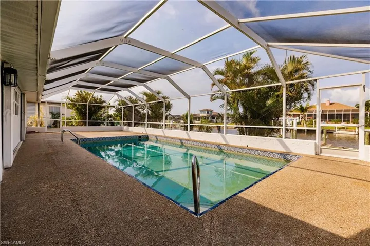 View of pool with a patio and a lanai