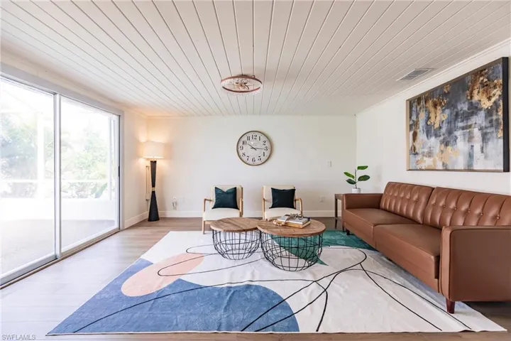 Living room with hardwood / wood-style floors and wooden ceiling