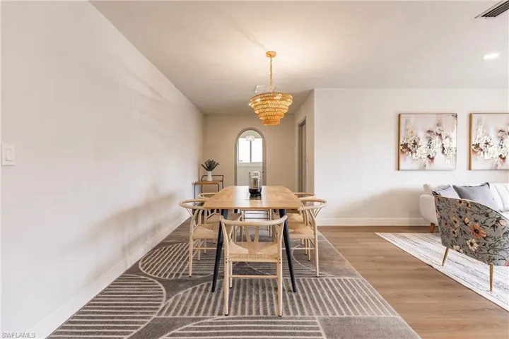 Dining area featuring a chandelier and wood-type flooring