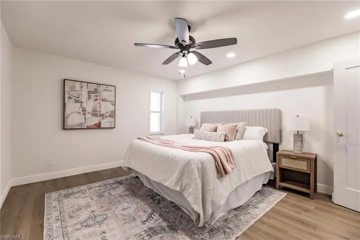 Bedroom with ceiling fan and hardwood / wood-style floors