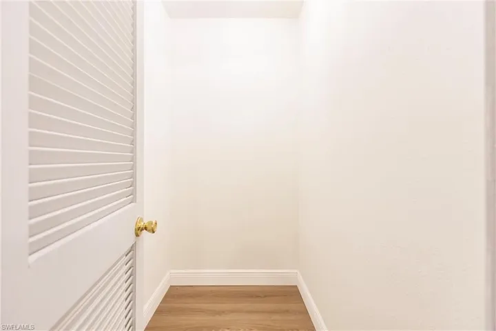 Walk in closet featuring hardwood / wood-style flooring