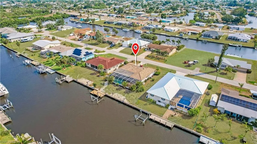 Birds eye view of property with a water view