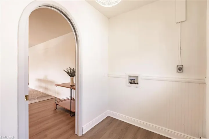 Clothes washing area with electric dryer hookup, hookup for a washing machine, and hardwood / wood-style flooring