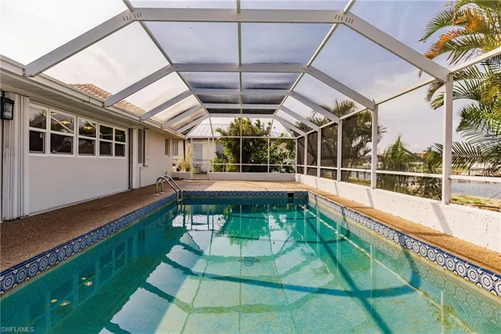 View of swimming pool with glass enclosure