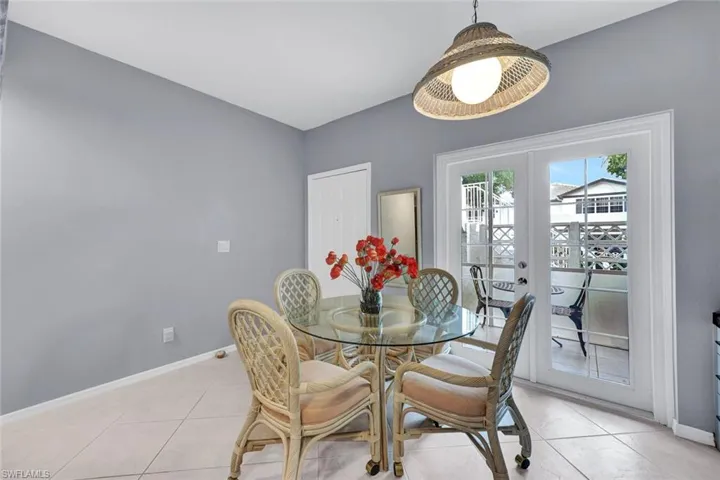 Tiled dining room with french doors