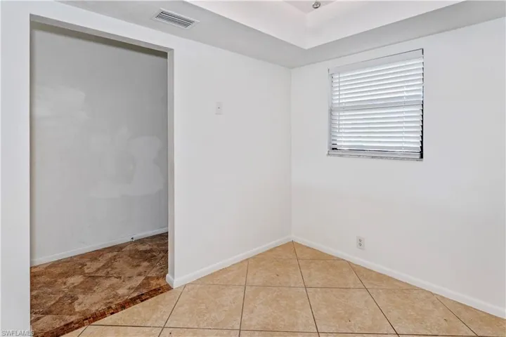 Spare room with light tile patterned floors and baseboards