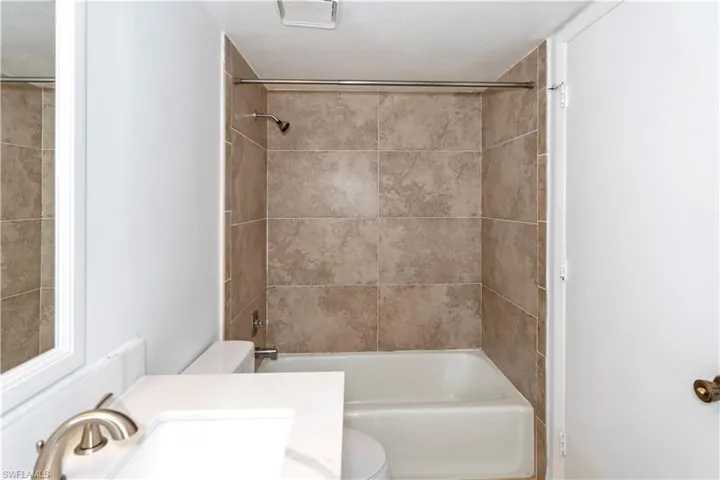 Bathroom with shower / bath combination and vanity