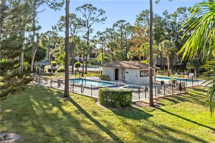 Community pool with a patio, a gazebo, a community hot tub, and view of scattered trees